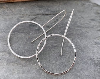 Large hoop earrings made from hammered silver in a simple, contemporary design