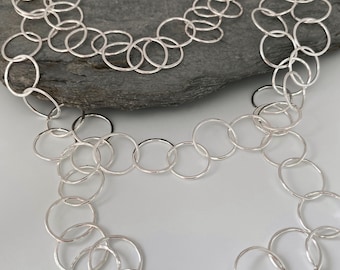 Long handmade sterling silver chain necklace with three layers, made from large round open hammered silver links