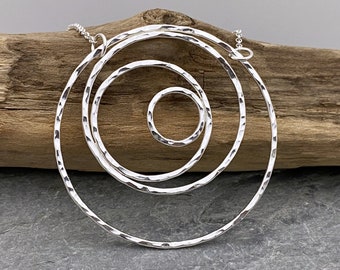 Large round silver circles statement pendant handmade from hammered silver.