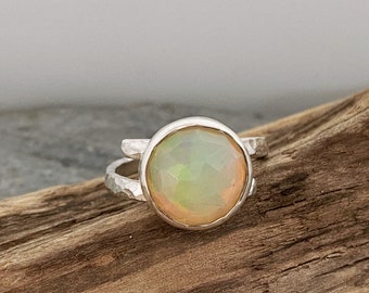 Stunning Ethiopian Opal statement ring. Wrap around silver ring band set with a large Opal stone. Chunky Opal ring.