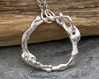 Organic silver circle pendant made from molten recycled silver