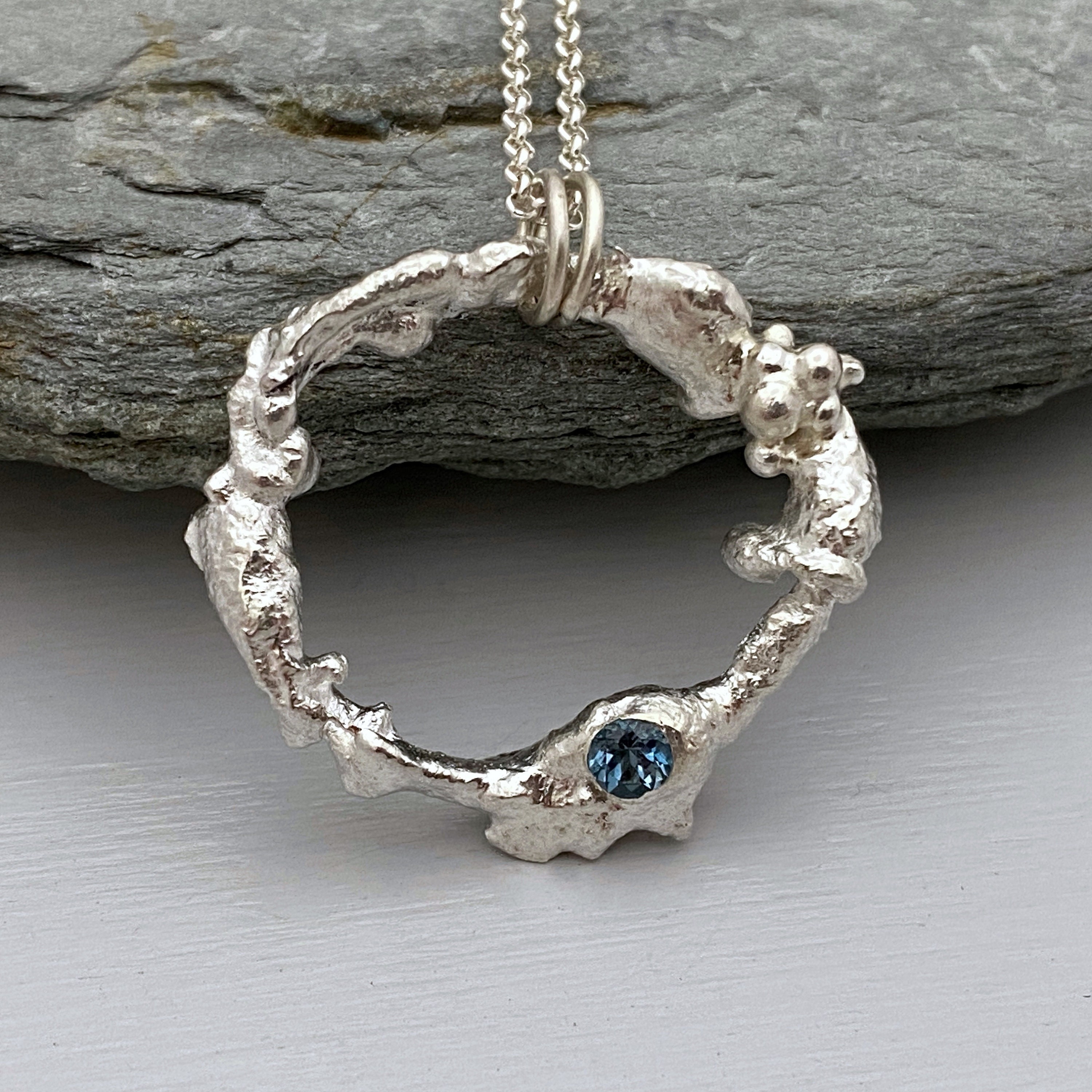 Molten Silver Circle Necklace Set With A Deep Blue Topaz Gemstone, Organic Pendant