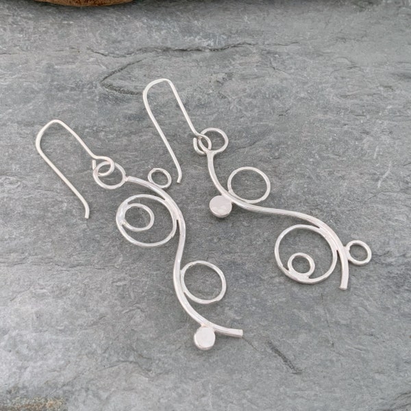 Long dangly silver earrings with an asymmetrical style, handmade from recycled sterling silver