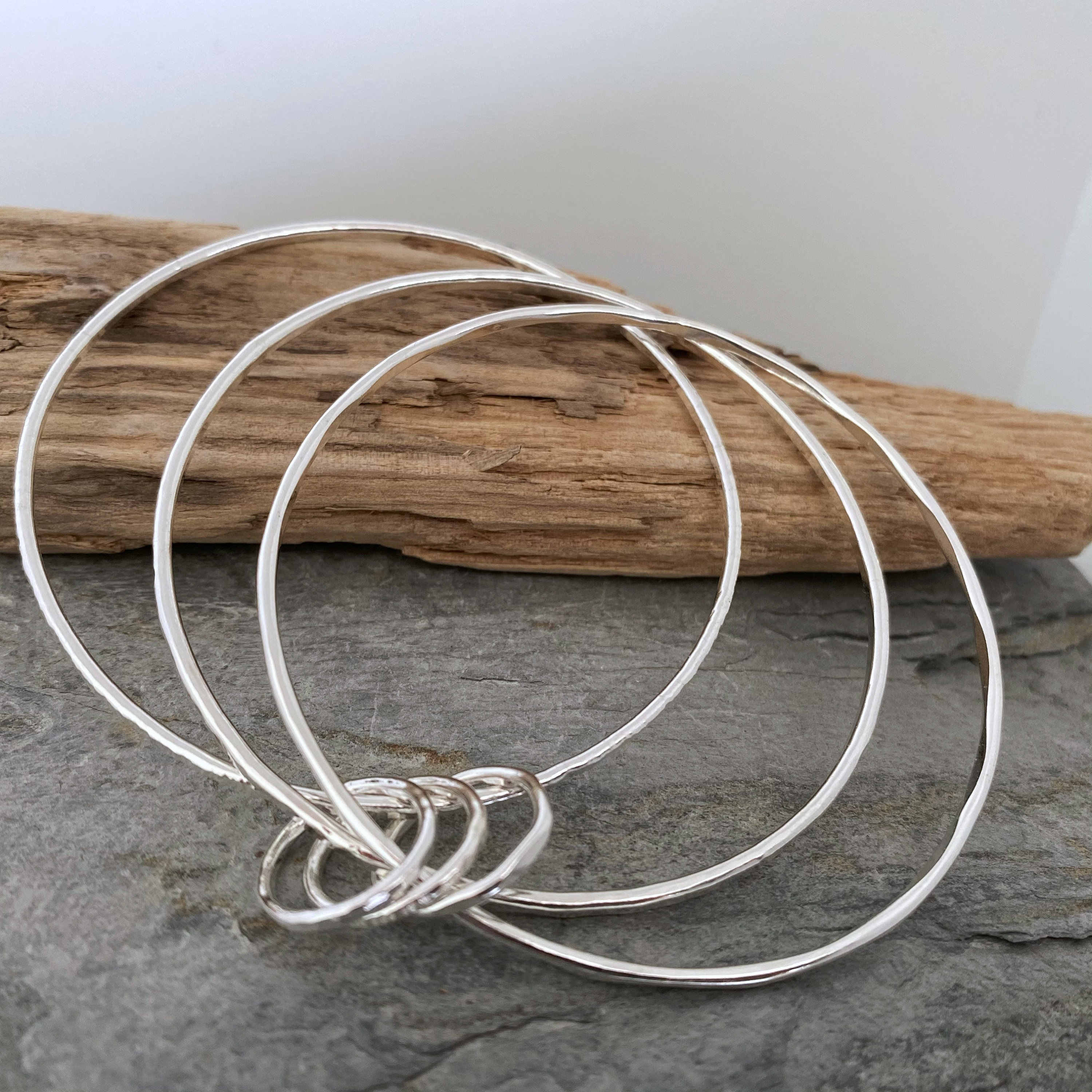 Set Of Three Hammered Silver Stacking Bangles Linked With Matching Rings, Made From Hallmarked, Sterling