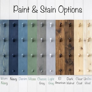 May include: A selection of wooden planks showcasing paint and stain finishes. Colours range from black and navy to moss and grey, with options like walnut. Each plank features pegs. The text at the top says "Paint & Stain Options."