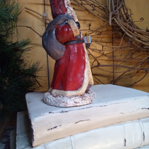 Santa / 4.5" Tall Vintage Antique Style Primitive Decor Resin Santa In A Wine Robe Matching Hood And Carrying A Grey Bag Over His Shoulder