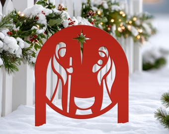 May include: A red metal circular yard sign featuring a cutout silhouette of a nativity scene with a star at the top. The design depicts two figures standing on either side of a central manger, all contained within a solid red circular frame.