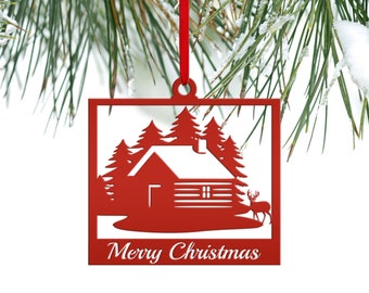 May include: Red metal Christmas bauble depicting a cabin in the woods with a deer. The bauble has a white background and the words "Merry Christmas" at the bottom.