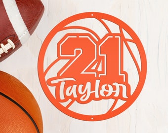 May include: Orange basketball-themed metal sign with the number 21 and the name "Taylor" in white lettering.