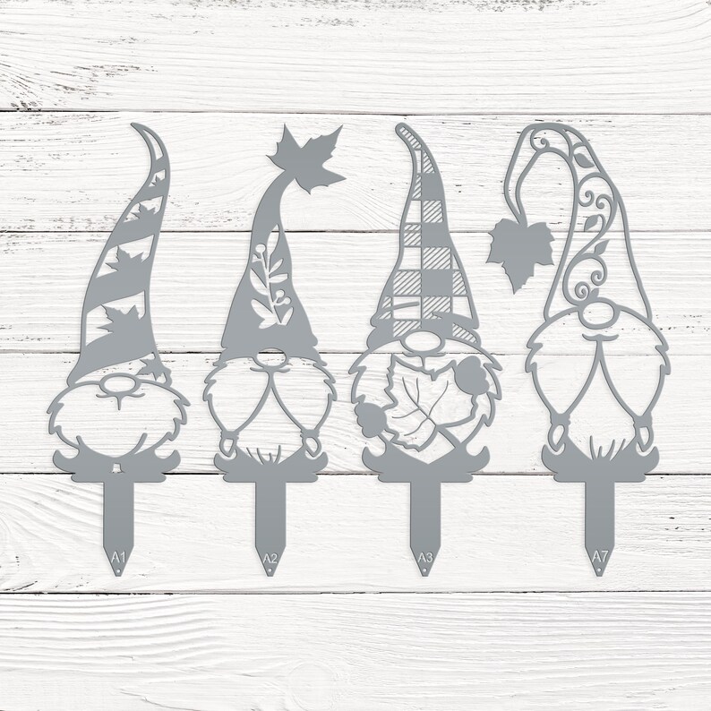 May include: Four gray metal garden gnomes with different hat designs. Each gnome has a stake at the bottom for easy placement in a garden or flower bed. The hats feature leaf and plaid patterns.