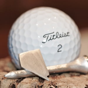 Golftee och/eller bollmarkörer i massivt sterlingsilver
