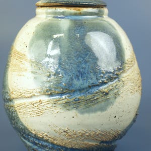 Vintage Handcrafted Artisan Pottery Jar with Lid Signed by Travis Hunt Blue Cream and Brown 6.5" in Mint Condition - drain hole in bottom