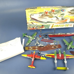 May include: A selection of Airfix model kits, including a Short Sunderland flying boat, various aircraft, and a ship. The box is labelled "Short Sunderland" and "Airfix 72 Scale Kits".