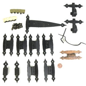 May include: A set of black and copper hinges for doors and gates. The set includes a variety of sizes and styles, including strap hinges, T-hinges, and butterfly hinges. The hinges are made of metal and have a hammered finish. The set also includes screws for installation.