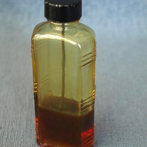 Vintage Clear Glass Bottle with Bakelite Cap with Gear Oil - 1/3 full - 4.5" tall x 1.75" wide x 1" deep
