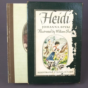 May include: A green hardcover book with the title "Heidi" by Johanna Spyri, illustrated by William Sharp. The book is part of the Illustrated Junior Library series and features a colorful illustration of a girl with goats on the front cover.