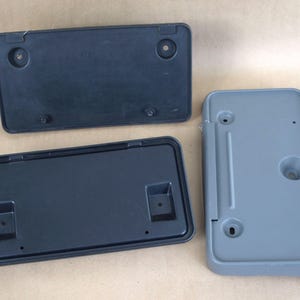 Ford License Plate Brackets - XF5Z-17A385-AA (92-97 F Series) - FOCZ-17A385-AC and F7UZ-17A385-Abw (1997 - 2001 Econoline) - nos