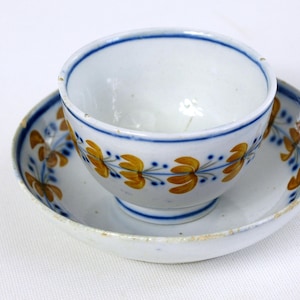 Antique English Soft Paste Porcelain Tea Cup and Saucer w Blue & Orange Floral Pattern Circa 1800s In Good Condition