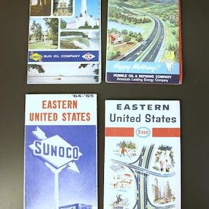 May include: Four vintage road maps from the 1960s and 1970s for the Eastern United States. The maps are from Sunoco and Esso, featuring illustrations of cars, landscapes, and gas stations. The maps are in blue, red, and white.