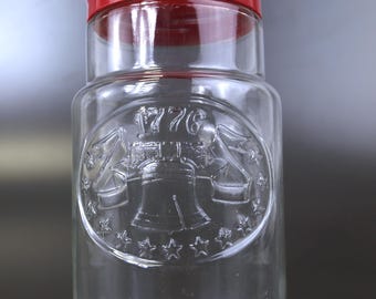 Vintage Anchor Hocking 1776 Bicentennial glass storage jar featuring Liberty Bell design, circa 1970s