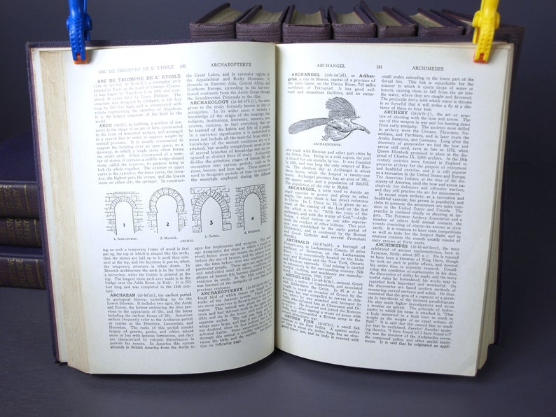 May include: An open book with brown leather covers and gold page edges. The book is titled "Arch&aelig;opteryx" and "Archangel" and contains text about the history of the arch and the history of the city of Archangel, Russia. The book is open to pages 198 and 199.