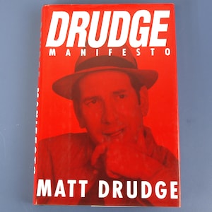 May include: A book cover with a red background features the title "DRUDGE MANIFESTO" in large white letters. Below the title is a red-toned image of a man wearing a hat. The author's name, "MATT DRUDGE," is printed in white at the bottom.