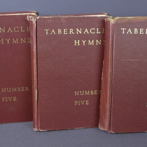 May include: Three burgundy-colored hardcover books with gold lettering. The books are titled "Tabernacle Hymns Number Five".
