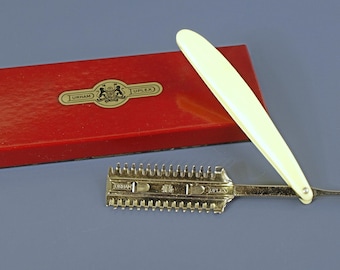 Vintage Durham Duplex straight razor with a celluloid handle in its original red and black case, circa 1930s