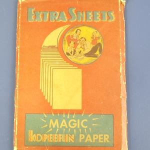 May include: Vintage orange booklet titled "EXTRA SHEETS" with a green and yellow design. The cover features a circular illustration of people and a stack of yellow paper. The bottom section reads "MAGIC KOPEEFUN PAPER".