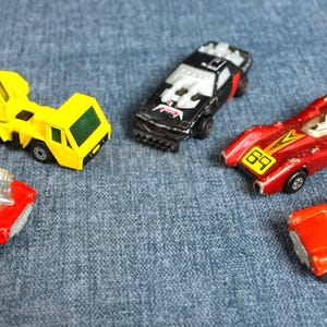Vintage Matchbox Lot - 1975 Superfast #14 Mini-Ha-Ha, 1970 #29 Racing Mini, 1984 Flash Force 2000, 1973 Rolamatics #69, 1978 Crane Truck #49
