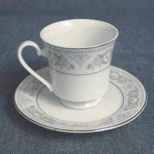 CCA International Fine China Porcelain Tea Cup w Saucer Floral Vine Design with Silver Trim