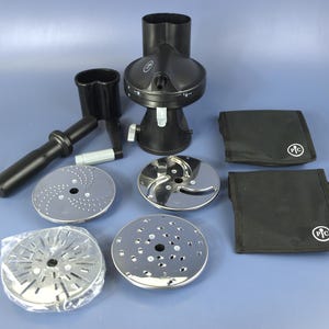 May include: A black food processor with multiple stainless steel blades and accessories. The set includes a food chute, a handle, and two black storage pouches. The items are arranged on a blue surface.
