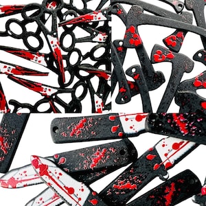 May include: A collection of black metal knives and scissors with red blood splatter. The knives and scissors are scattered on a white background.