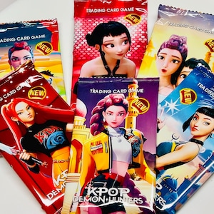 May include: A collection of sealed trading card game packs. Each pack features a different anime-style illustration of a woman and the text "TRADING CARD GAME" and "NEW". The packs are in various colors, including red, blue, and yellow.