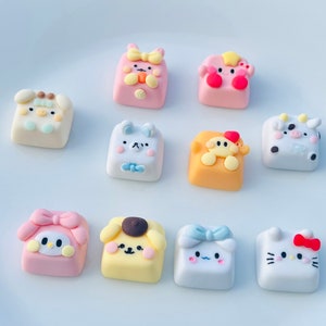 May include: Ten colorful keycaps with different cartoon characters, including a bunny, a pig, a bear, a cow, a chick, a dog, a cat, and a penguin. The keycaps are made of resin and have a glossy finish.