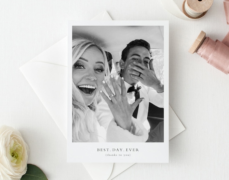 May include: Black and white photograph of a couple in a car. The bride is smiling and the groom is covering his face with his hands. The text "BEST. DAY. EVER (thanks to you)" is below the photo.