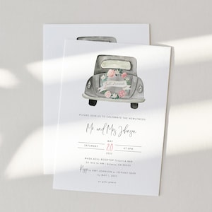 May include: A wedding invitation featuring a watercolour illustration of a vintage car adorned with flowers and a "Just Married" sign. The invitation is for Mr. and Mrs. Johnson's wedding on 20 May 2022, at 6 PM at Masa Azul Rooftop Tequila Bar in Atlanta, Georgia.