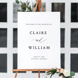 May include: White wedding welcome sign with black text. The sign reads "Welcome to the wedding of Claire and William, June 24, 2020, Atlanta, Georgia".