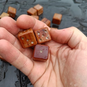 A pair of hand carved vintage micarta dice. Last set