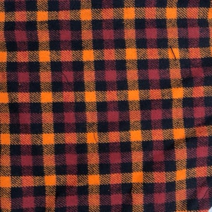 May include: Orange, black, and burgundy plaid fabric with a woven texture.