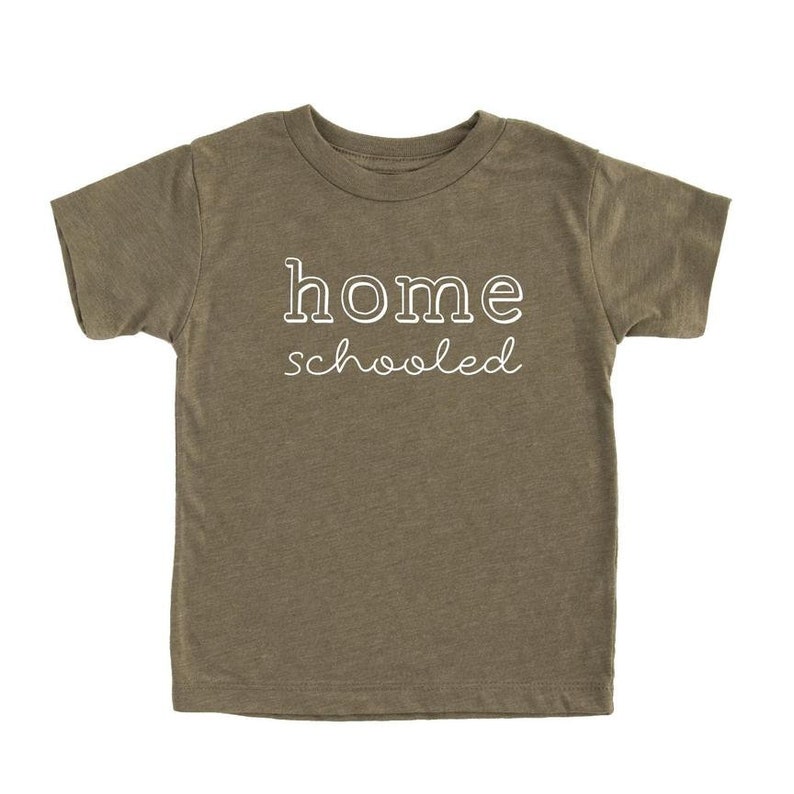 May include: A green short-sleeved t-shirt with the text "home schooled" in white.