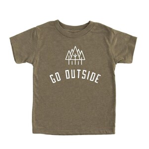 May include: A green short-sleeved t-shirt with a white graphic of a mountain range and trees. The text "GO OUTSIDE" is printed below the graphic.