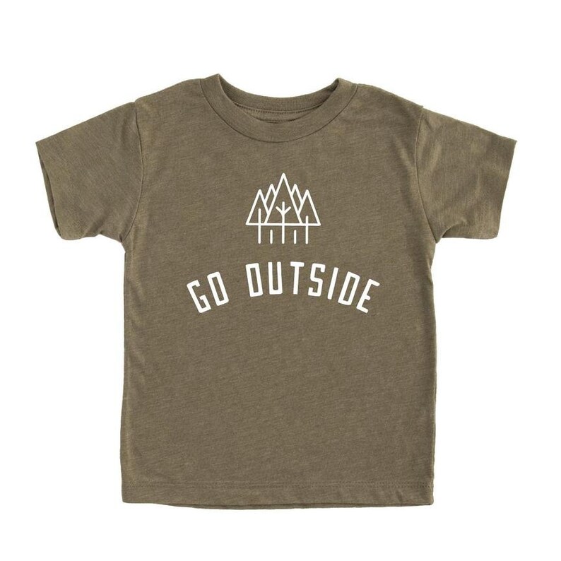 May include: A green short-sleeved t-shirt with a white graphic of a mountain range and trees. The text "GO OUTSIDE" is printed below the graphic.