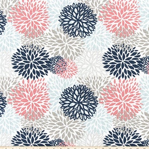 May include: A white fabric with a repeating pattern of pink and navy blue stylized flower shapes. The fabric has a subtle texture.