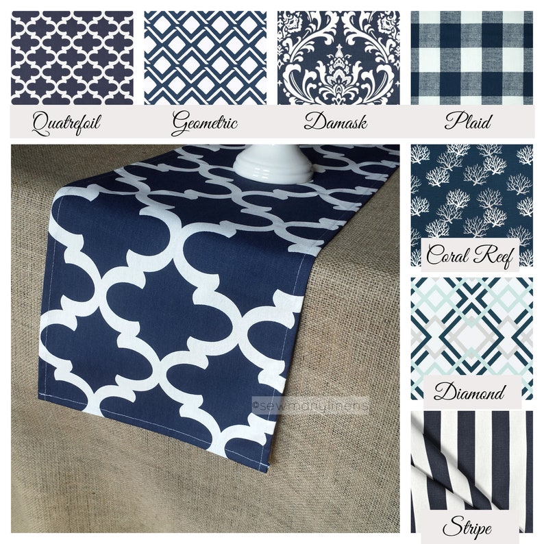 May include: A navy blue table runner with a white quatrefoil pattern. The runner is displayed on a hessian surface. The image also shows a variety of other table runner patterns, including geometric, damask, plaid, coral reef, diamond, and stripe.