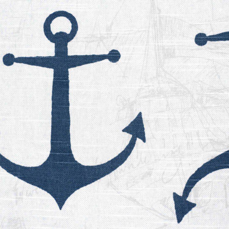 May include: White fabric with a repeating pattern of navy blue anchors. The anchors are stylized with a classic design. The background has a subtle nautical map design, creating a coastal theme.