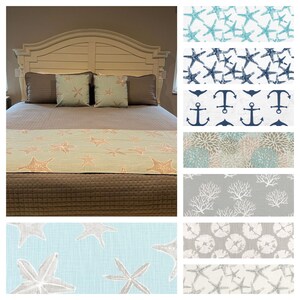 May include: A bed with a light blue and beige bed runner with a starfish pattern. The bed runner is on a brown bedspread. The headboard is white with a wood grain finish. The image also shows a variety of different fabric swatches with nautical themes, including starfish, anchors, coral, and seashells.