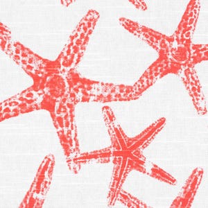 May include: A white fabric featuring a repeating pattern of bright coral-colored starfish. The starfish have a textured, stamped appearance with visible white gaps within the coral-colored ink, creating a high-contrast design on the textile.