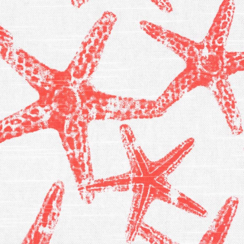 May include: A white fabric featuring a repeating pattern of bright coral-colored starfish. The starfish have a textured, stamped appearance with visible white gaps within the coral-colored ink, creating a high-contrast design on the textile.