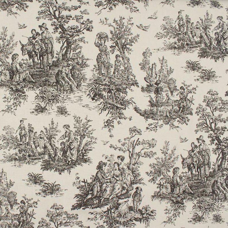 May include: Cream-colored fabric with a repeating toile pattern in black. The design depicts scenes of people in a pastoral setting, including figures, trees, and animals. The overall aesthetic is classic and detailed, suitable for various home decor projects.